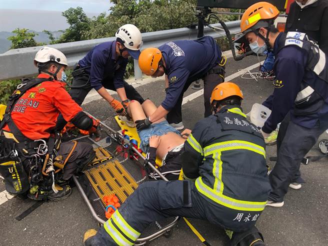 嘉义县消防局用吊臂吊挂篮式担架救郑姓男子脱困，并初步救护。（嘉义县消防局提供／廖素慧嘉县传真）