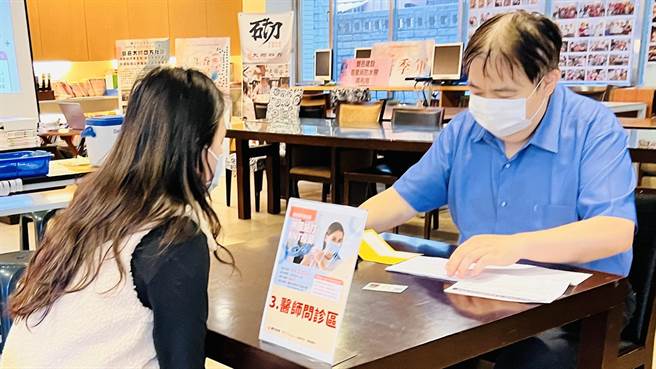 医师问诊仔细，住户打完疫苗观察后就能上楼回家休息。（卢金足摄）