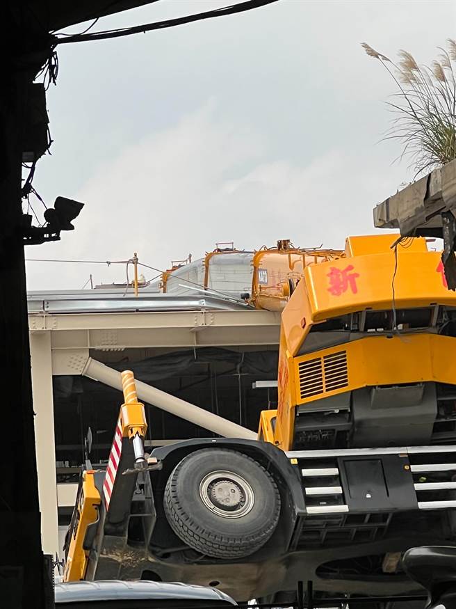 第一果菜批发中继市场工程发生工安事故，一辆吊车翻车卡在屋顶上。（第一市场自救会提供）