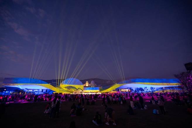 高市府力挺乌克兰，透过乌克兰国旗的蓝黄色，形成一道道光束，点亮亚洲新湾区及卫武营夜空，希望天佑乌克兰。（柯宗纬翻摄）