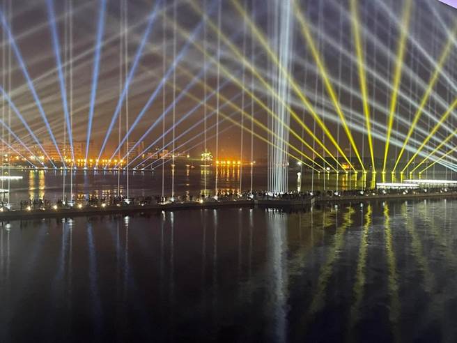 高市府力挺乌克兰，透过乌克兰国旗的蓝黄色，形成一道道光束，点亮亚洲新湾区及卫武营夜空，希望天佑乌克兰。（柯宗纬翻摄）