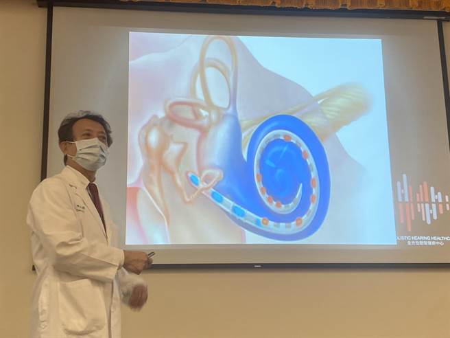 中国附医全方位听觉健康中心副院长陈光超指出，人工电子耳原理为挂在耳后的处理器接收声波，讯号传入内耳的电极刺激听神经产生听觉。（冯惠宜摄）