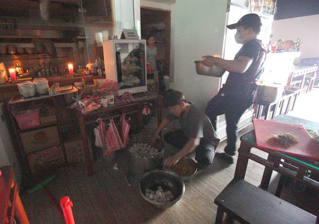 全台多处3日发生大停电，早餐店除了冷藏设备受影响外，继续摸黑营业，顾客用手机持续关注停电的最新消息。（张铠乙摄）