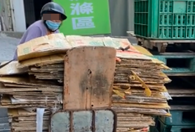 1名網友日前目睹1名拾荒婦人在路邊為整疊紙箱「澆水」，他上前詢問婦人是否是「用水增重」以變賣更多錢，婦人點頭承認。（翻攝自TikTok帳號「chenqpqp」）
