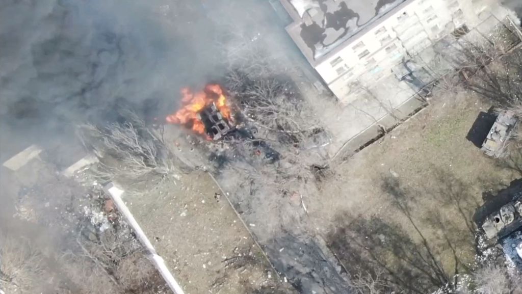 3月13日上传的空拍照显示，俄罗斯持续侵略乌克兰，南部大城马立波（Mariupol）的建筑旁有一辆军车起火。（路透）(photo:ChinaTimes)