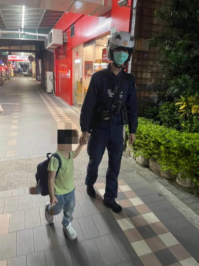 小男童见到警察叔叔向他保证会替他找到妈妈，便主动握住警察叔叔的手。（芦竹警分局提供／陈梦茹桃园传真）