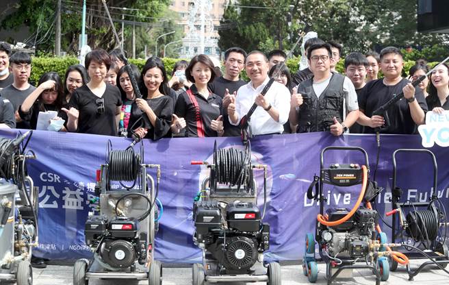 新北市长侯友宜（右3）出席在板桥435艺文特区举行的公益洗地板活动，偕同「做工的人」作者林立青（右2）、和泰汽车经理谢琴韵（左3）等赞助厂商及NGO青年，一同举起清洗机具刷洗广场角落。（郑任南摄）