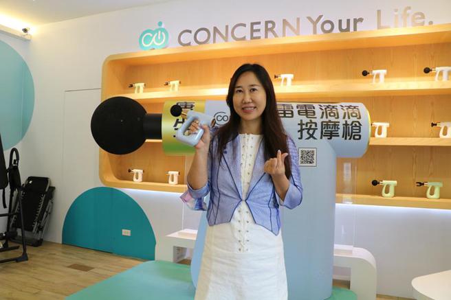 （康生健康科技董事長白如娟，24日在旗下「筋膜槍體驗館」，手持公司2022筋膜槍新機型，替產品代言。圖／劉朱松）