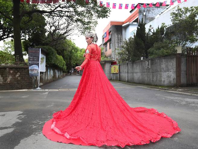 新北市多元文化節3日在新北市空軍三重一村熱鬧登場，參與展出的印尼新娘祕書公司，特別帶來印尼傳統的新娘禮服，在三重一村吊掛的國旗下走秀，引起民眾讚美的驚呼。（鄭任南攝）