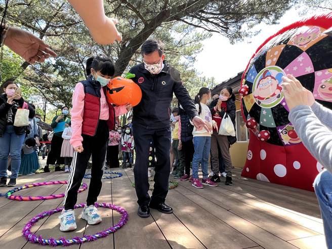 桃园儿童玩具图书馆欢庆1周年，甫拿下经营权的如果儿童剧团，4日搭配儿童节推出各项活动，吸引逾千名亲子同乐，市长郑文灿也和小朋友一起玩夹球障碍闯关游戏。（蔡依珍摄）