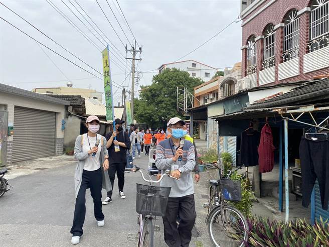 中正大学重构大学路计画「烈风光影户外照片展」7日上午开展，嘉义县民雄乡丰收村林家后代林伟烈带着学生导览，讲述在地人文歷史。（张亦惠摄）