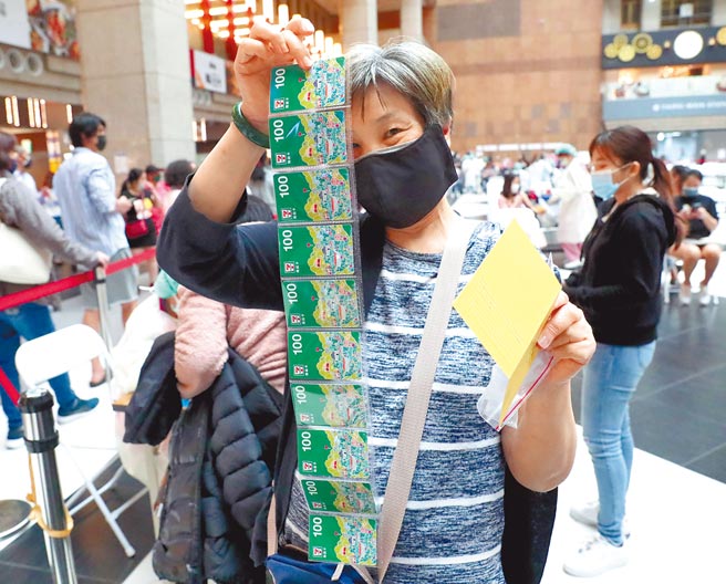 为了提高长者施打新冠肺炎疫苗意愿，台北市政府7日起对设籍台北市65岁以上的民眾，只要于北市合约医疗院所及中型接种站接种疫苗1、2剂、基础加强剂或追加剂，除中央给的500元礼券外，再加码500元礼券，共可获得1000元礼券。一位民眾7日在台北火车站广场的接种站施打新冠肺炎疫苗后，高兴的展示领到的1000元超商礼券。（郑任南摄）