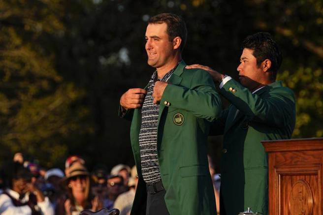 薛弗勒(左)拿下美国名人赛冠军，去年冠军松山英树帮他穿上绿夹克。（美联社）