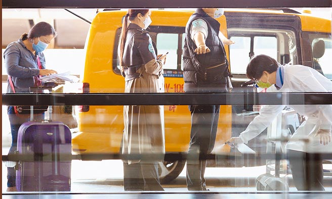 外交部昨天宣布即日起放宽国人及持有我国有效居留证在台湾的非本国籍人士（不含移工）的外籍亲属，可向我国驻外馆处申请探亲事由的「特别入境许可」（停留签证）来台。图为在桃园机场第一航厦入境大厅外，防疫车队工作人员替搭车旅客全身消毒。（范扬光摄）