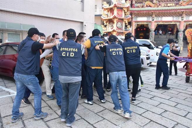 警方向宫庙借来神轿，模拟警方在护轿过程遭遇民眾抢轿、抢娘伞等衝突状况。（民眾提供／卢金足台中传真）