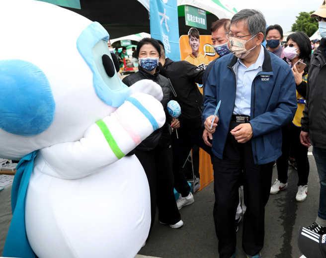 台北市長柯文哲（右）17日出席台北科技盃愛地球公益路跑活動，順便參觀現場的攤位，好奇的看著攤位上的吉祥物。（鄭任南攝）