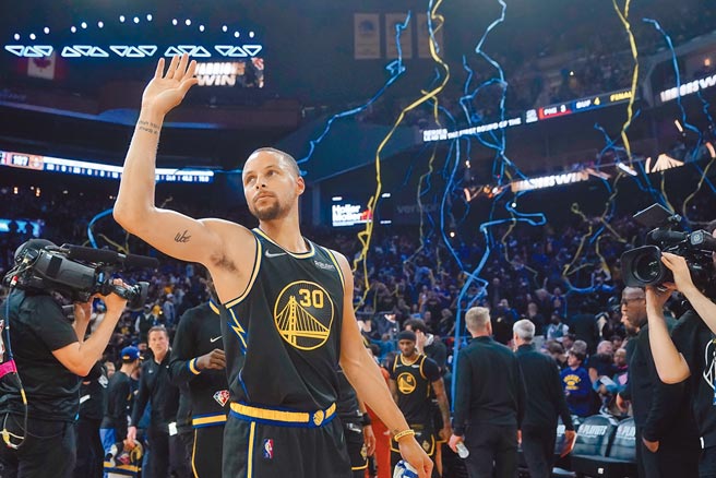 当勇士抛出胜利彩带，柯瑞高举右手跟观眾致意。（美联社）