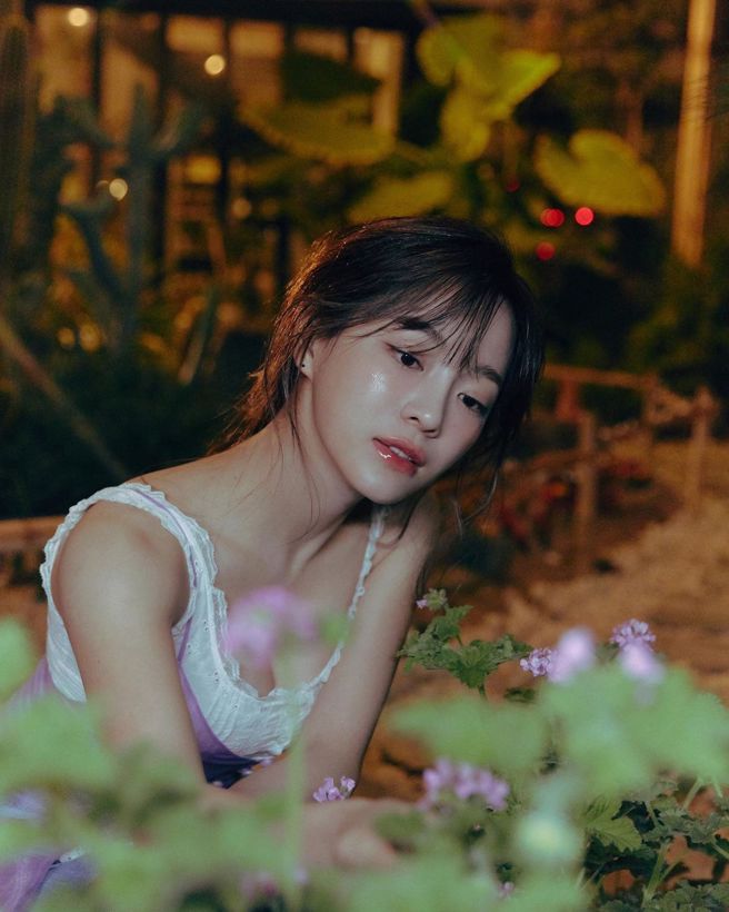 金世正穿着白色背心在花园里漫步，难得见光的事业线电力超强。（图／取自金世正IG）