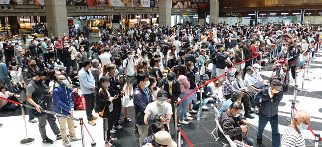 本土疫情持续升温，图为台北车站疫苗接种站23日再度涌入大批施打疫苗的民眾，车站外亦出现排队人潮。（姚志平摄）
