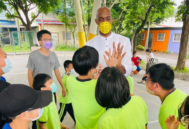戴维斯跟内城国中小学生进行篮球互动。(戴维斯提供)