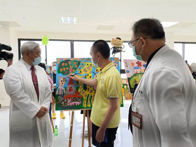 病患（中）跟董事长李顺安(左)、院长许景琦（右）介绍自己的创作。（陈淑娥摄）