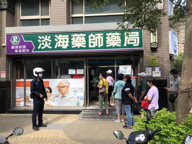 淡水警方在藥局外維護秩序。（警方提供）