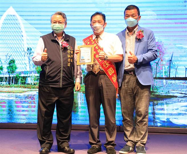 台中市去年首次舉辦職人傳承新秀選拔活動，獲選職人張國揚（中），由副市長令狐榮達（左）頒獎表揚。（陳世宗攝）
