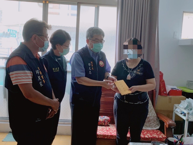 嘉邑行善团徐文志理事长(右二)发送扶助救助金予新住民金兰(右一)。(移民署嘉义市服务站提供)