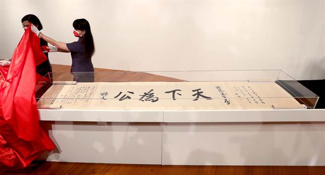 国父纪念馆5日举行五十周年馆庆活动启动仪式，工作人员为首次展出的国父墨宝《天下为公》揭开布幔。（郑任南摄） 