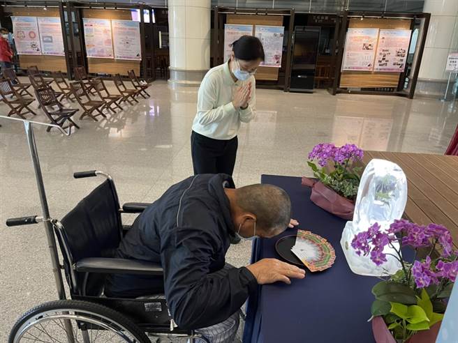 張先生在大廳浴佛台前浴佛，祝福全天下媽媽母親節快樂。（台中慈濟醫院提供）