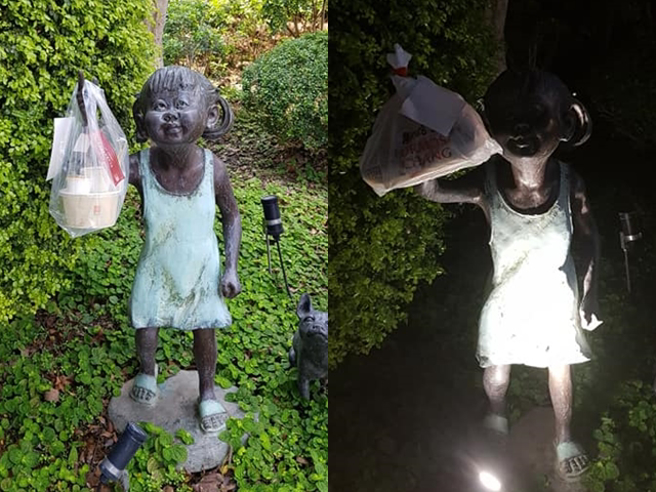 外送員把餐掛在小女孩雕像手上，沒想到外送員創意進化，小女孩不但手上掛餐，耳朵也掛餐，就連一旁小狗雕像，狗嘴也掛餐。（翻攝自臉書臉書「爆廢公社」）