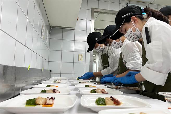 弘光科大餐旅系學生聚精會神準備畢業成果發表會。(弘光科大提供)