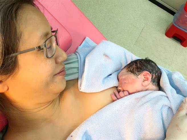 傅姓产妇以「温柔生产」的方式生下第三胎，如愿亲自剪脐带，还走下产台拓印胎盘作画留念。（高雄市立联合医院提供／袁庭尧高雄传真）