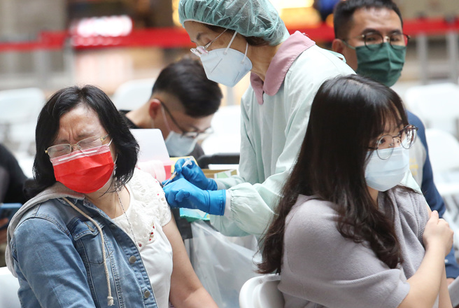 本土疫情严峻，不少民眾纷纷到台北车站接种站施打疫苗。（范扬光摄）