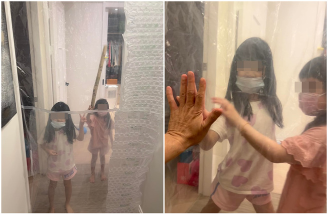 伊正只能隔着塑胶帷幕和两个女儿对望。(伊正脸书)