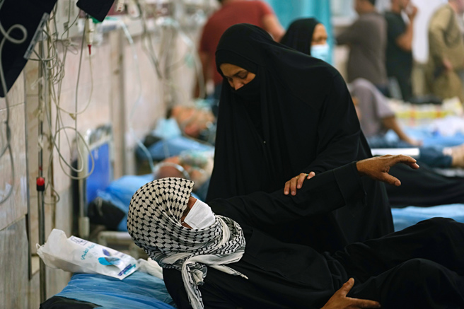 伊拉克全國各地有逾1000人因呼吸系統問題送醫。(圖／美聯社)