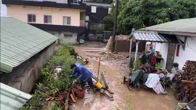 连日豪雨导致宜兰县头城镇滨海路七段发生土石流，水流泥石掩盖路面，低洼地方都是泥泞，无法行走。（民眾提供／吴佩蓉宜兰传真）