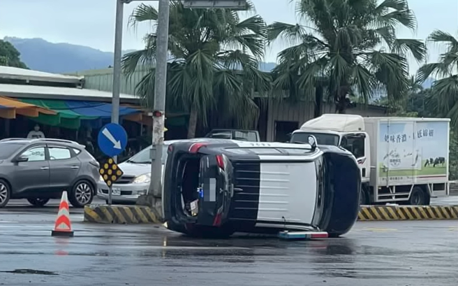 1辆警车在路口因不明原因朝路中分隔岛靠去，当场左车身往上翻「侧立路中」。（翻摄自YouTube频道「WoWtchout - 地图型行车影像分享平台」）