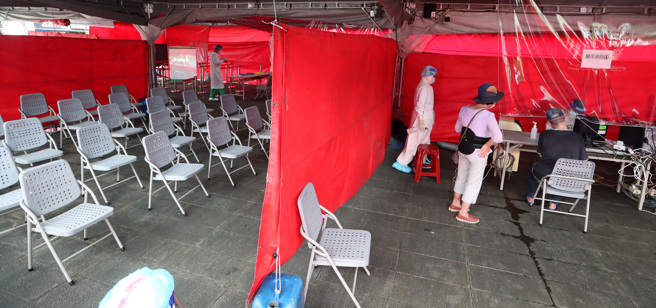 本土疫情持续蔓延，民眾在筛检站接受筛检。（郑任南摄）