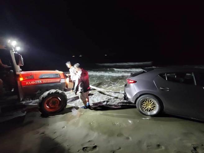 竹南警分局外埔派出所员警协助受困水尾沙滩民眾座车脱困。（竹南警分局提供／谢明俊苗栗传真）