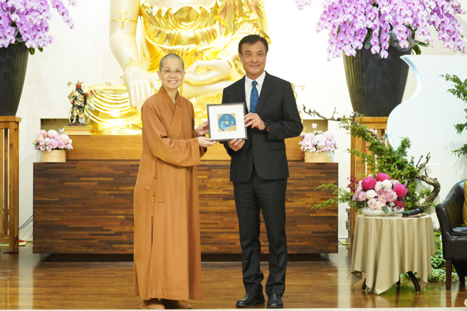 觉居法师(左)致赠讲座光碟感谢苏嘉全(右)。(图/佛光山惠中寺)