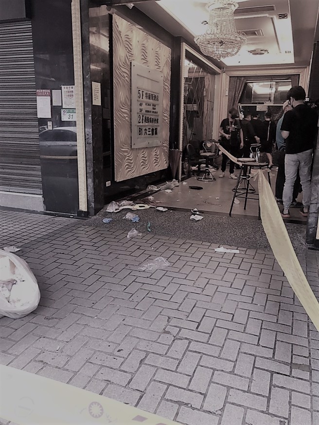 北市長春路及林森北路口一家酒店應晨發生鬥毆，1名男子遭3人圍毆狂砍，左胸中刀倒血泊無生命跡象，警方圍起封鎖線進行鑑識。(戴志揚翻攝)