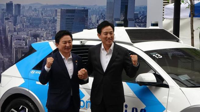  首尔市长吴世勋（右）国土交通部长元喜龙（左）9日宣布自动驾驶计程车RoboRide服务将于8月在江南区正式提供服务，6、7月将先进行试营运。（图/ 中央社）