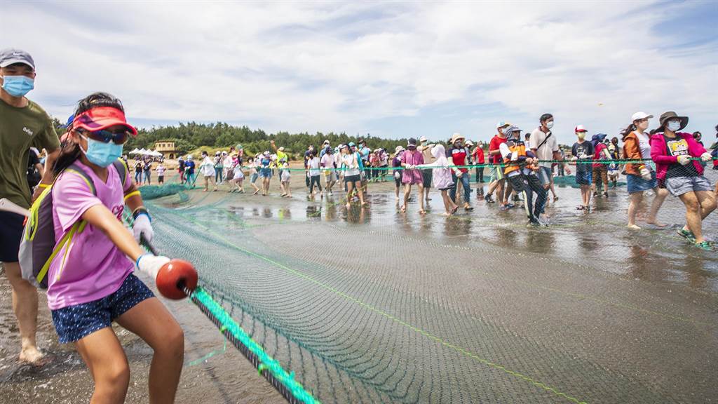 竹北市新月沙灘牽罟文化祭，大小朋友合力將漁網拉上岸。（羅浚濱攝）