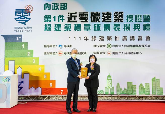 （第一银行获「绿建筑标竿企业奖」，由内政部次长吴堂安(左)颁奖、第一银行处长吴淑贞(右)代表受奖。图／第一银行提供）