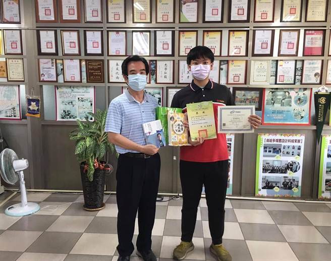 育德工家校长张荣修(左)赠书鼓励涂弘逸实现梦想。(育德工家提供／刘秀芬台南传真)