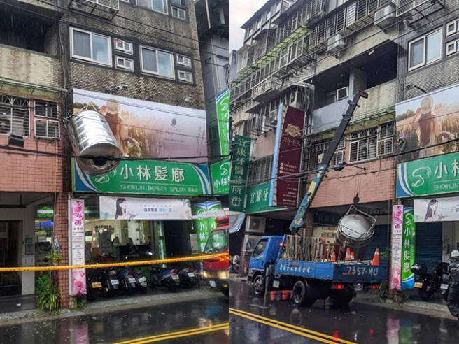 新北市安和路一处民宅屋顶的水塔被风雨吹落，卡在电缆线、挂在半空中。（民眾提供）