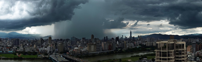 大台北地区25日上午天气炎热，但过中午之后风云变色、乌云密布，并在台北上空形成雨瀑。（姚志平摄）