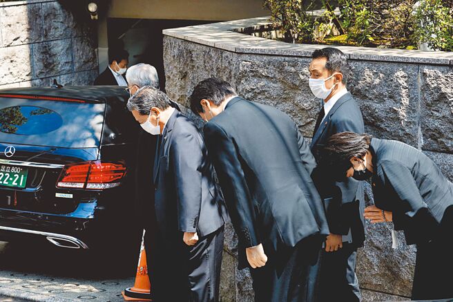 日本前首相安倍晋三前天遭枪击身亡，9日清晨遗体由灵车移送离开奈良的医院，中午过后运返东京住所，数名自民党员鞠躬默祷。（路透）