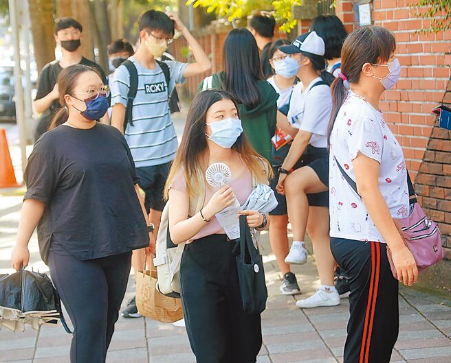 首届大学分科测验11日登场，由于天气炎热，有考生拿着手持电风扇进入考场。（陈君玮摄）